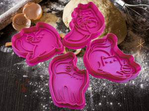 Pink cat-themed cookie cutters for creative holiday baking on a flour-dusted kitchen countertop.