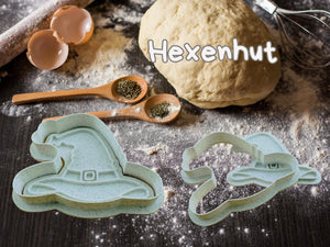 Halloween witch hat cookie cutter with dough and spices on a baking table.