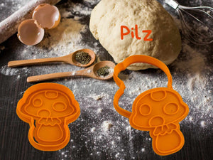 Keks-Ausstecher in Pilzform aus orangefarbenem Kunststoff, ideal für herbstliches Backen.