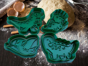 Set of green dinosaur cookie cutters - T-Rex, Stegosaurus, and more, perfect for baking enthusiasts and dinosaur fans.
