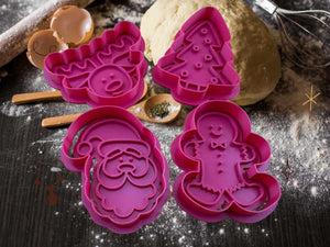 Purple Christmas cookie cutters: reindeer, tree, gingerbread man, and Santa on festive baking setup.