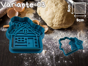 Christmas cookie cutter shaped like a house on a kitchen table with dough and baking ingredients.