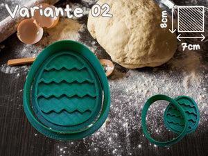 Green egg-shaped cookie cutter on flour-dusted baking surface with dough and rolling pin