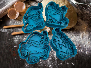 Set of four blue gnome-shaped cookie cutters on a rustic baking surface, perfect for festive Christmas baking fun.
