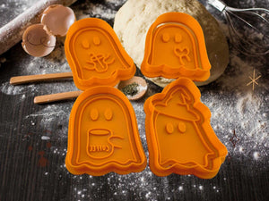 Halloween ghost cookie cutters in orange, featuring four spooky designs on a flour-dusted surface.