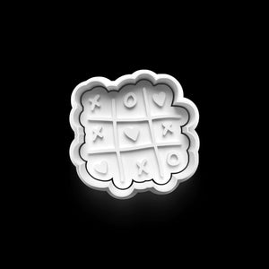 Tic-Tac-Toe-style heart cookie cutter for romantic Valentine's Day baking projects, made of PETG plastic.