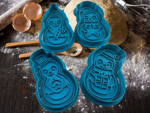 Blue penguin cookie cutter set on baking table with dough, perfect for festive cookie baking and holiday fun.