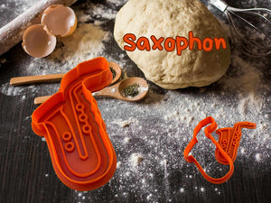 Orange saxophone cookie cutter in kitchen with dough and baking tools, adding a musical touch to your baking creativity.