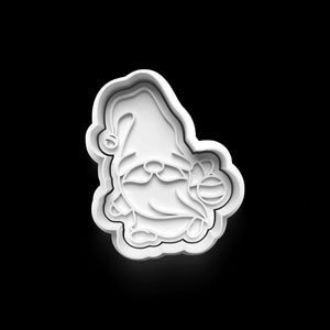 White gnome-shaped cookie cutter for festive baking fun.