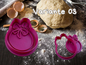 Festive Christbaumkugel cookie cutter in vibrant pink, perfect for holiday baking with dough and spices on a floured surface.