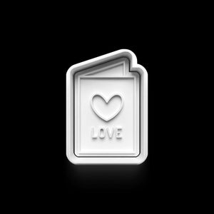 Valentine's Day cookie cutter shaped like a love card with heart and "LOVE" text, perfect for romantic baking occasions.