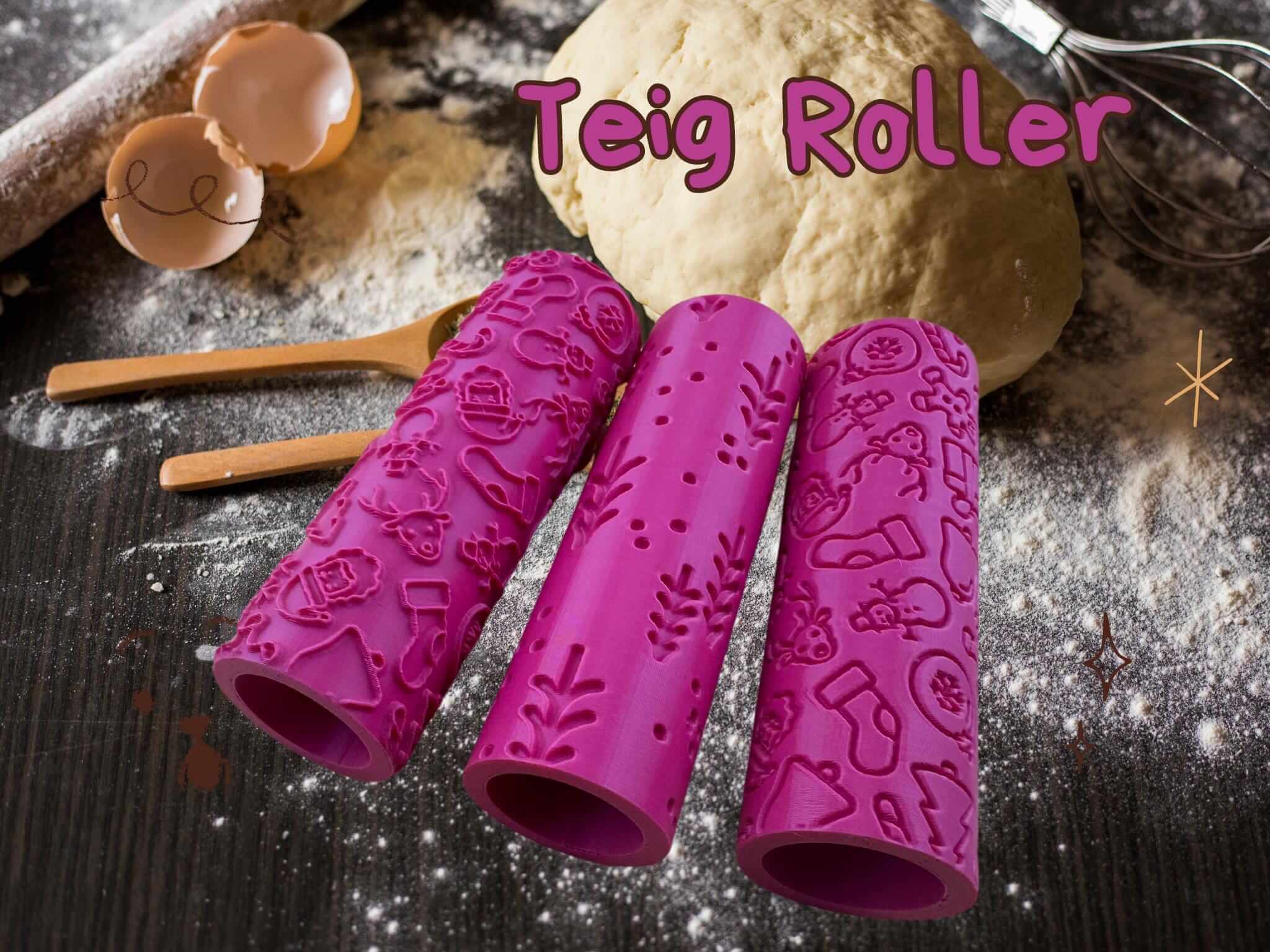 Three pink rolling pins with Christmas patterns on a baking table with dough and wooden utensils.