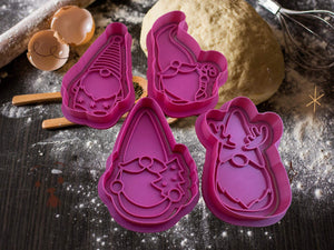 Festive Christmas gnome cookie cutters set on a baking table, ready for creating whimsical holiday treats with dough in the background.