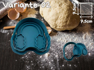 Teal cookie cutter set shaped like earmuffs on a baking surface with dough and eggs for festive winter baking.