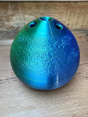 Funky blue-green yarn bowl with texture, ideal for knitting and crochet projects.