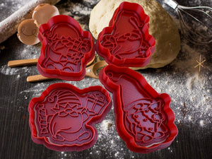 Set of four red gnome-themed Christmas cookie cutters on a floured kitchen counter, ready for festive baking fun.
