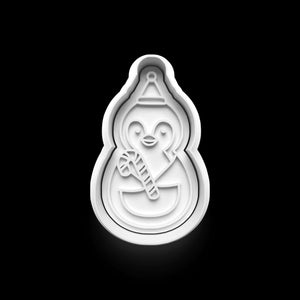 Cute penguin cookie cutter holding a candy cane, perfect for winter baking and festive holiday treats.