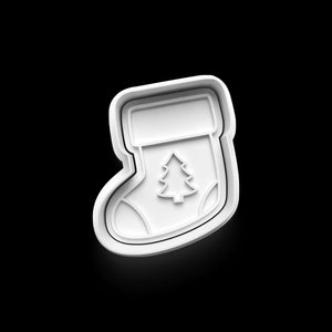 White Christmas stocking cookie cutter with tree detail on a black background, perfect for festive baking projects.
