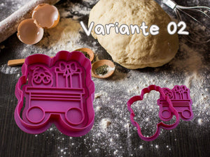 Festive pink gift wagon cookie cutter from the Weihnachtszug set on a baking table with dough and eggs.