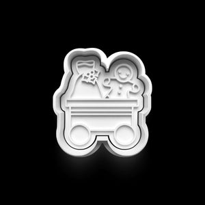 Christmas cookie cutter mold shaped like a train wagon with a gingerbread man and gift sack design.