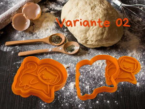 Niedliche orangefarbene Keks-Ausstecher in Katzenform auf einem Tisch mit Keksteig und Löffeln.